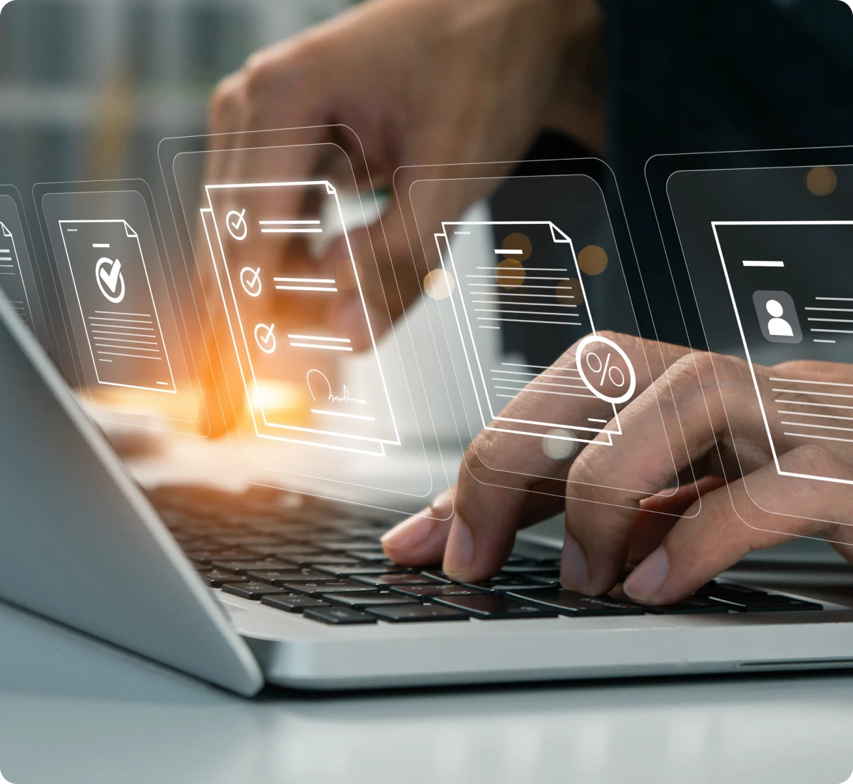 Hands typing on laptop with digital icons.